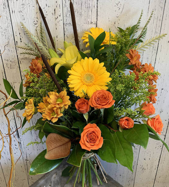 An image of a fall, orange and yellow coloured, cut flower bouquet