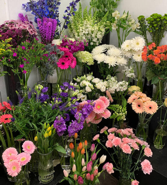 An image of a cluster of different flowers in a cooler