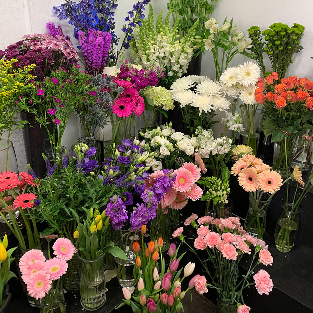 An image of a cluster of different flowers in a cooler